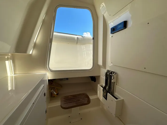  Yacht Photos Pics Interior cabin of 2017 Boston Whaler 330 Outrage with window and seating.