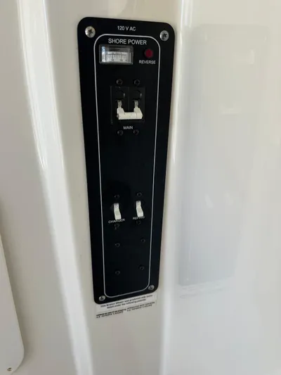  Yacht Photos Pics Control panel on 2017 Boston Whaler 330 Outrage boat, featuring shore power switches.