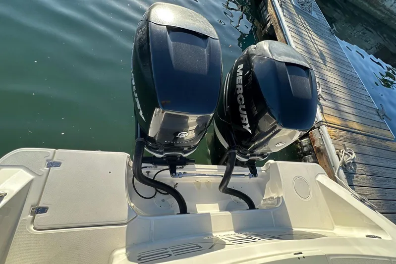  Yacht Photos Pics 2017 Boston Whaler 330 Outrage with twin Mercury outboard engines docked by the water.