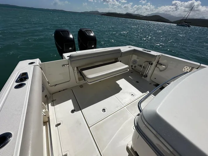  Yacht Photos Pics 2017 Boston Whaler 330 Outrage boat deck with dual engines on a sunny day.