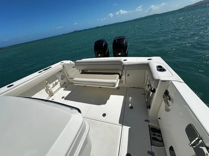  Yacht Photos Pics 2017 Boston Whaler 330 Outrage boat on open water, featuring dual engines and spacious deck.