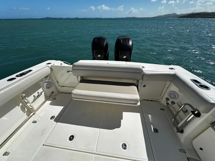  Yacht Photos Pics 2017 Boston Whaler 330 Outrage boat deck with twin engines on open water.