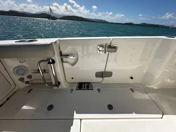 Yacht Photos Pics 2017 Boston Whaler 330 Outrage boat deck with ocean view and distant sailboat.