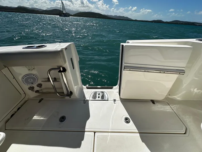 Yacht Photos Pics 2017 Boston Whaler 330 Outrage boat deck with ocean view and distant sailboat.