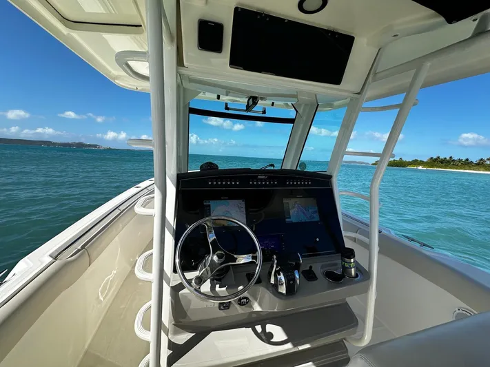  Yacht Photos Pics 2017 Boston Whaler 330 Outrage helm with ocean view and clear blue skies.