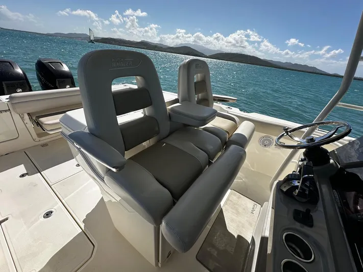  Yacht Photos Pics 2017 Boston Whaler 330 Outrage boat interior with dual seats, ocean view in background.