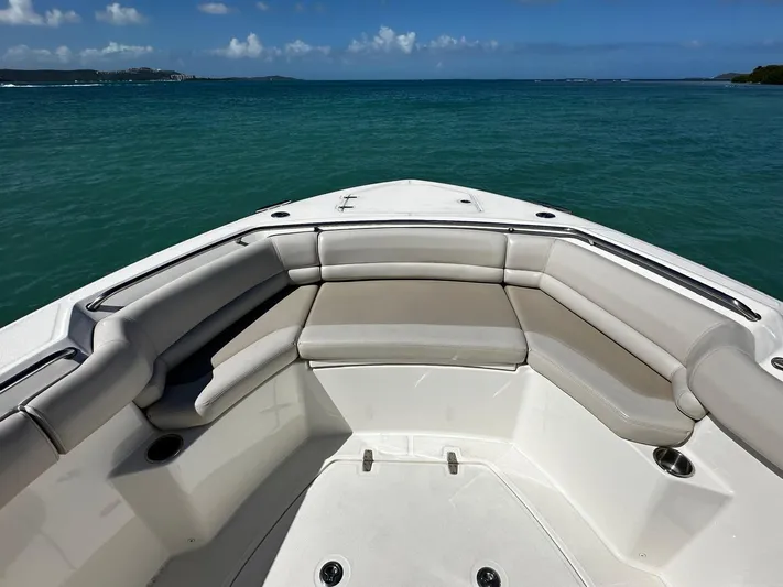  Yacht Photos Pics 2017 Boston Whaler 330 Outrage boat bow with cushioned seating, ocean view.