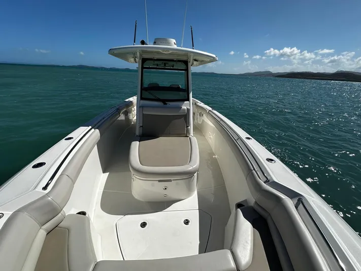  Yacht Photos Pics 2017 Boston Whaler 330 Outrage boat on open water, clear sky, and distant shoreline.