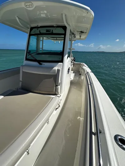  Yacht Photos Pics 2017 Boston Whaler 330 Outrage boat on open water, clear skies, and calm sea.