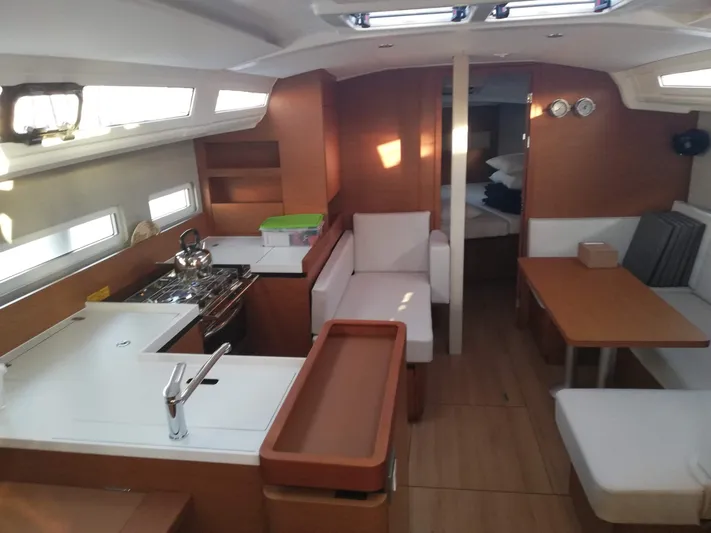  Yacht Photos Pics Interior of 2020 Jeanneau Sun Odyssey 410 sailboat, featuring modern kitchen and seating area.