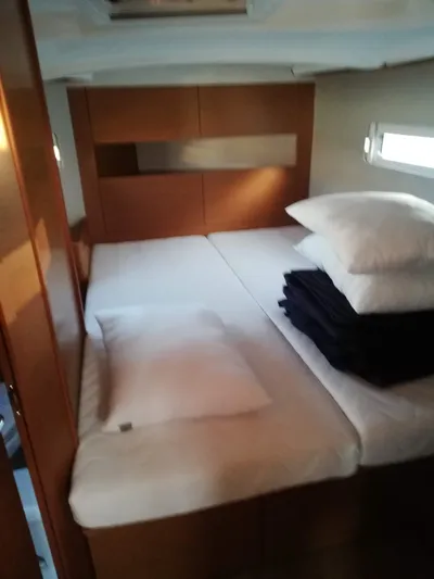  Yacht Photos Pics Cozy cabin interior of 2020 Jeanneau Sun Odyssey 410 sailboat with neatly arranged bedding.