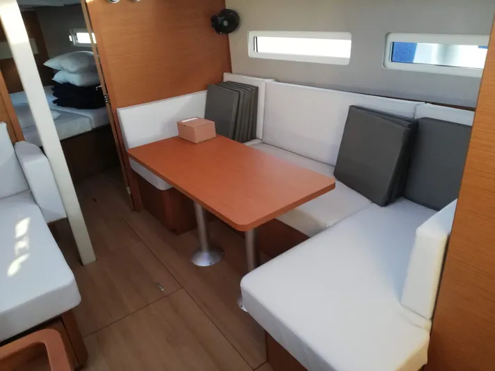  Yacht Photos Pics Interior of 2020 Jeanneau Sun Odyssey 410 with cozy seating and dining area.