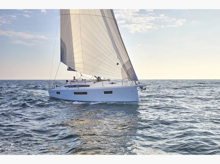  Yacht Photos Pics 2020 Jeanneau Sun Odyssey 410 sailing on open sea under clear sky.