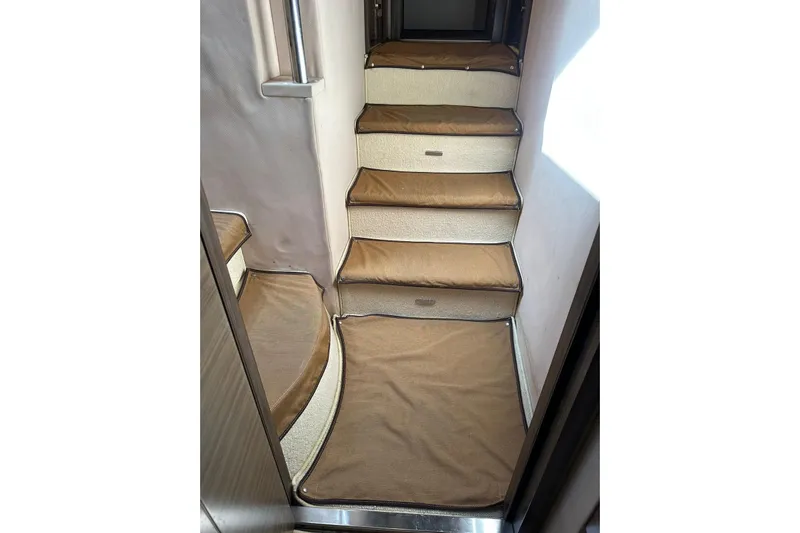 No Name Yacht Photos Pics Interior stairs of 2017 Azimut Fly yacht with brown carpeting.
