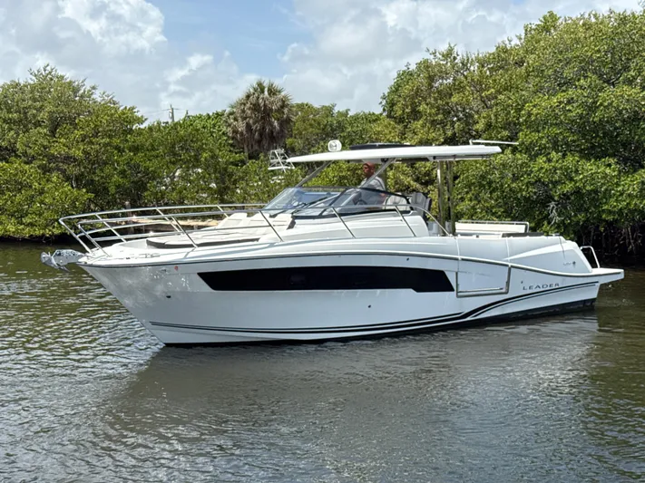  Yacht Photos Pics 2022 Jeanneau Leader 10.5 WA Series 2 boat cruising on a calm waterway.