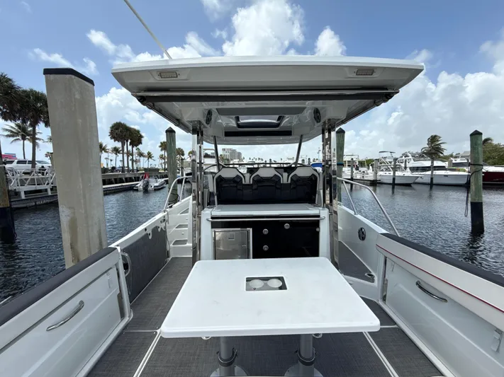  Yacht Photos Pics 2022 Jeanneau Leader 10.5 WA Series 2 boat interior at marina, featuring seating and table.