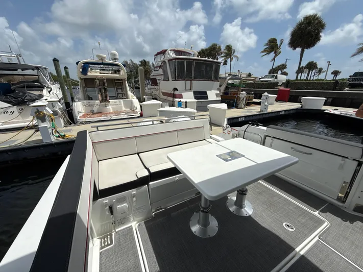  Yacht Photos Pics 2022 Jeanneau Leader 10.5 WA Series 2 docked, featuring spacious seating and table.