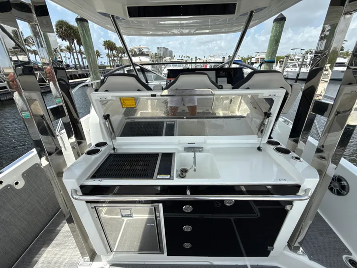  Yacht Photos Pics 2022 Jeanneau Leader 10.5 WA Series 2 boat interior with kitchenette and seating area.