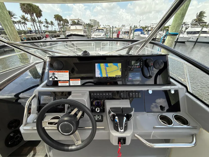  Yacht Photos Pics Helm of 2022 Jeanneau Leader 10.5 WA Series 2 with navigation display and controls.