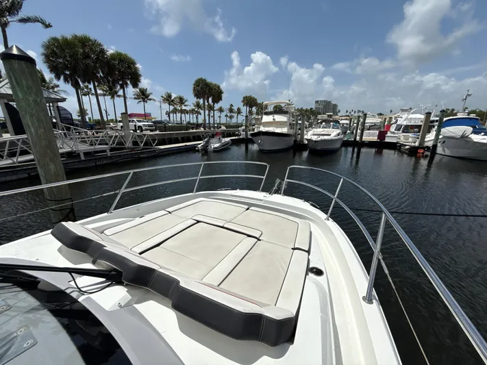  Yacht Photos Pics 2022 Jeanneau Leader 10.5 WA Series 2 docked at marina, surrounded by palm trees and boats.