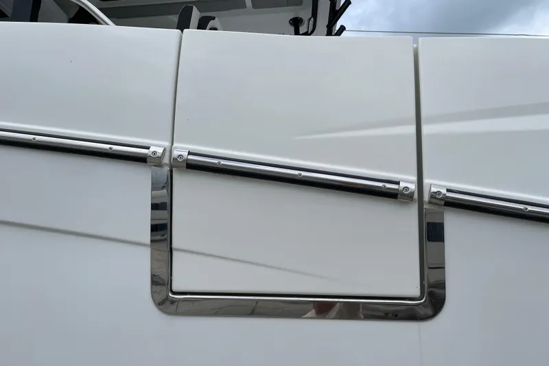  Yacht Photos Pics 2024 Jeanneau Leader 10.5 CC boat detail with sleek white paneling and chrome accents.