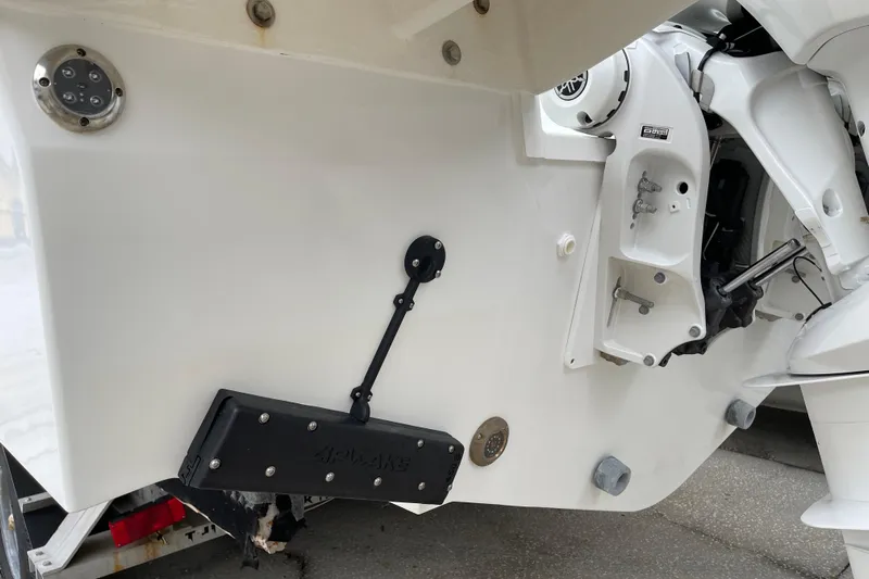  Yacht Photos Pics 2024 Jeanneau Leader 10.5 CC boat stern with trim tab and engine components.