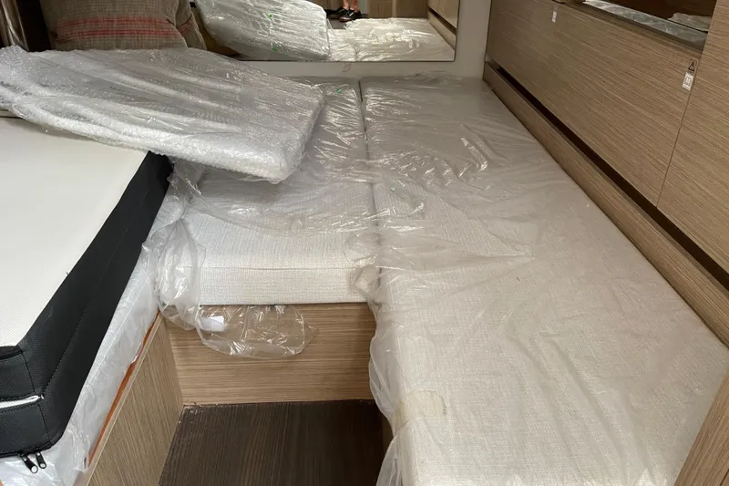  Yacht Photos Pics 2024 Jeanneau Leader 10.5 CC cabin interior with protective plastic covering.