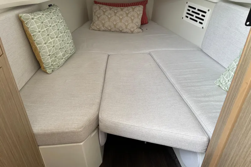 Yacht Photos Pics 2024 Jeanneau Leader 10.5 CC cabin interior with cozy cushions and modern design.