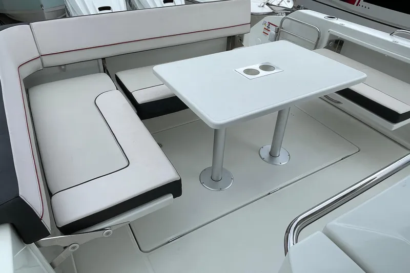  Yacht Photos Pics 2024 Jeanneau Leader 10.5 CC boat interior with seating and table setup.