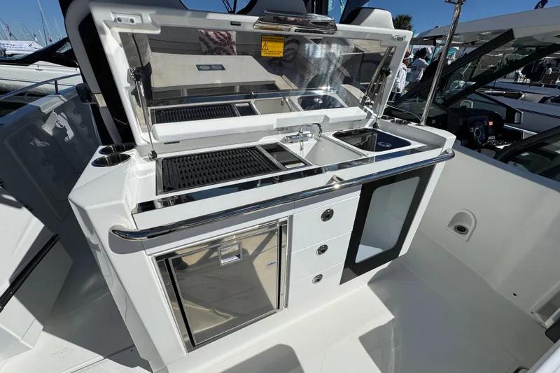  Yacht Photos Pics 2024 Jeanneau Leader 10.5 CC boat kitchen with sink, grill, and storage.
