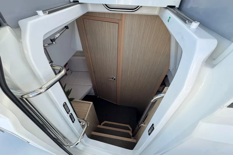  Yacht Photos Pics 2024 Jeanneau Leader 10.5 CC cabin entrance with wooden stairs and door.