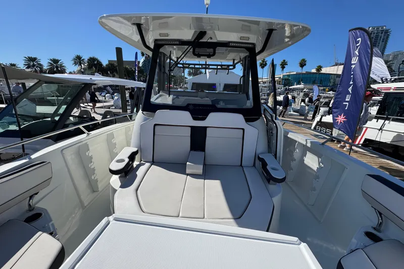  Yacht Photos Pics 2024 Jeanneau Leader 10.5 CC boat interior with seating, docked at marina.