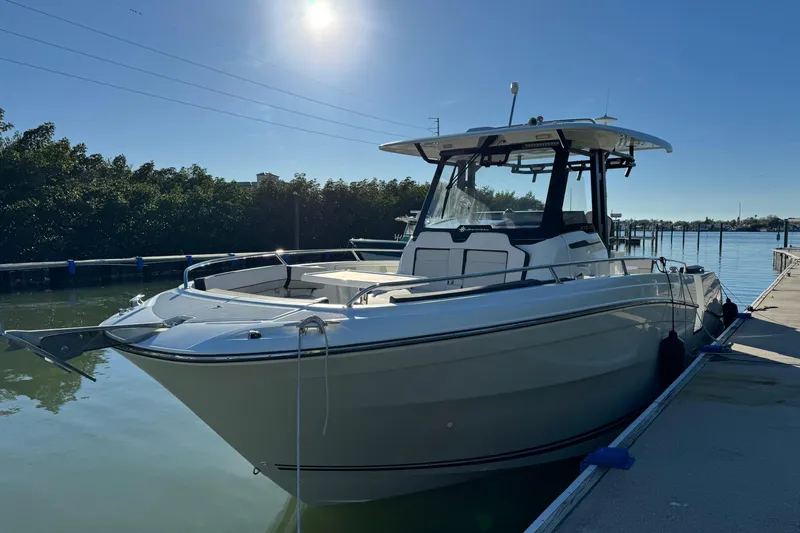  Yacht Photos Pics 2024 Jeanneau Leader 10.5 CC boat docked under clear blue sky.