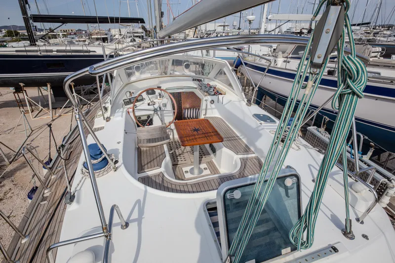  Yacht Photos Pics Cockpit view of 1999 Beneteau Oceanis 44 CC sailboat, showcasing helm and seating area.
