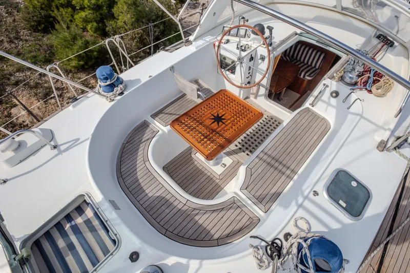  Yacht Photos Pics Cockpit of 1999 Beneteau Oceanis 44 CC sailboat with wooden accents and steering wheel.