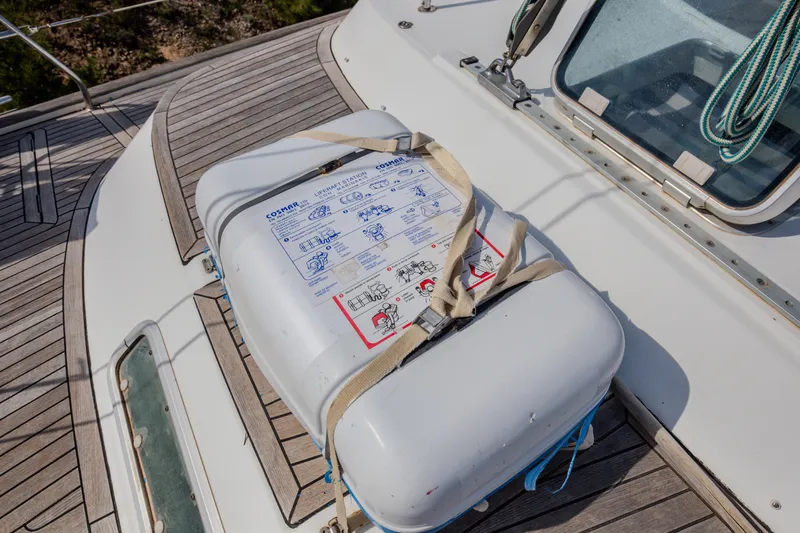  Yacht Photos Pics Liferaft on deck of 1999 Beneteau Oceanis 44 CC sailboat, secured with straps.