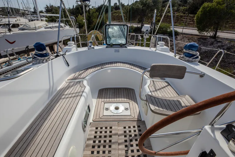 Yacht Photos Pics Cockpit of 1999 Beneteau Oceanis 44 CC sailboat with wooden seating and steering wheel.