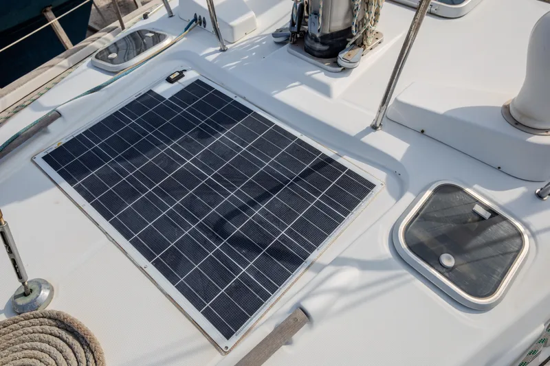  Yacht Photos Pics Solar panel on 1999 Beneteau Oceanis 44 CC yacht deck, enhancing energy efficiency.