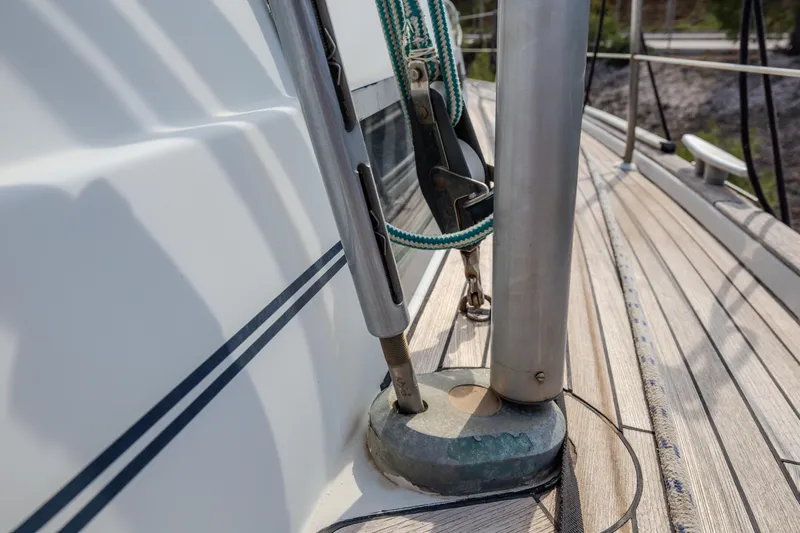  Yacht Photos Pics Deck detail of 1999 Beneteau Oceanis 44 CC sailboat, featuring rigging and teak surface.