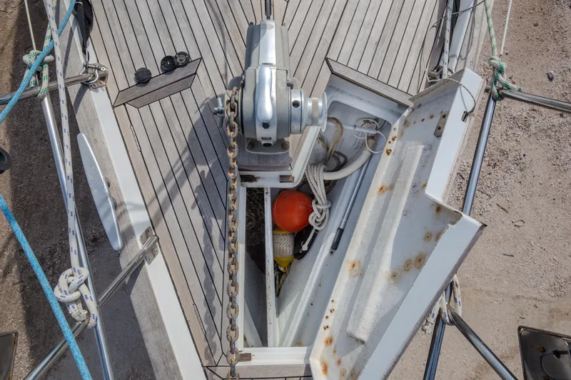  Yacht Photos Pics Deck view of a 1999 Beneteau Oceanis 44 CC sailboat with anchor chain and storage compartment.