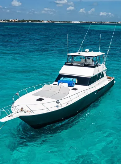 Good Life Yacht Photos Pics 1994 Viking Sport Fisherman yacht on clear turquoise water under a blue sky.