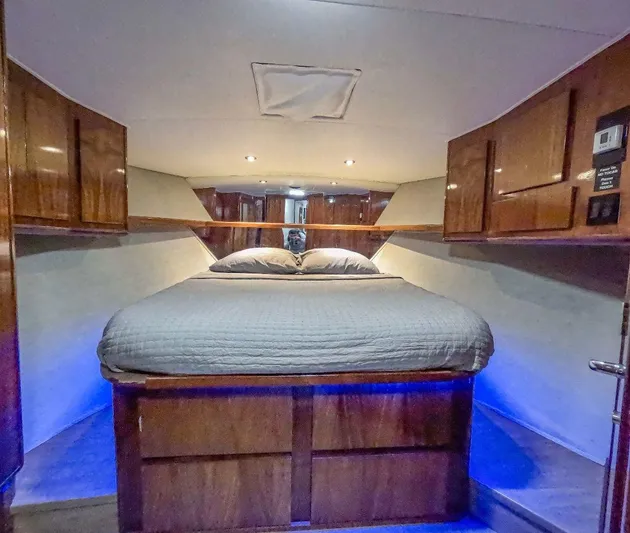 Good Life Yacht Photos Pics Luxurious cabin interior of 1994 Viking Sport Fisherman with cozy bed and ambient lighting.