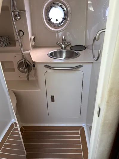  Yacht Photos Pics 2012 Sea Ray 350 Sundancer bathroom with sink, porthole, and shower.