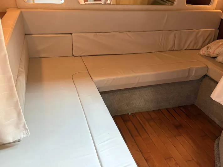  Yacht Photos Pics Interior seating area of a 2012 Sea Ray 350 Sundancer yacht with beige cushions.