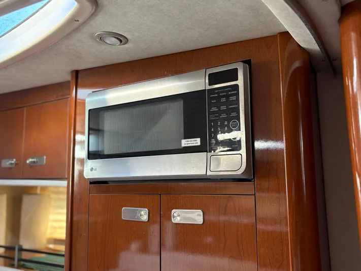  Yacht Photos Pics Microwave in 2012 Sea Ray 350 Sundancer yacht kitchen with wooden cabinetry.