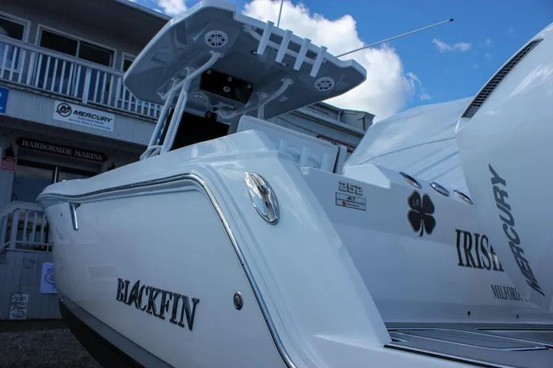 Irish Eyes Yacht Photos Pics 2023 Blackfin 252 CC boat with Mercury engines, docked at a marina under a blue sky.