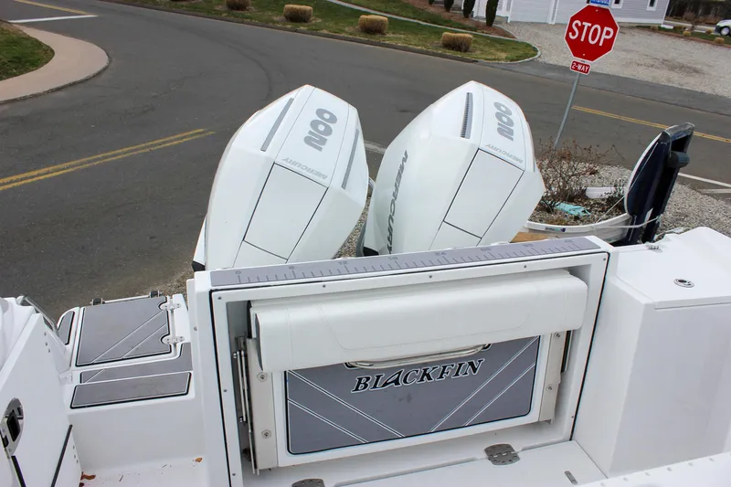 Irish Eyes Yacht Photos Pics 2023 Blackfin 252 CC boat with dual outboard engines, parked near a stop sign.
