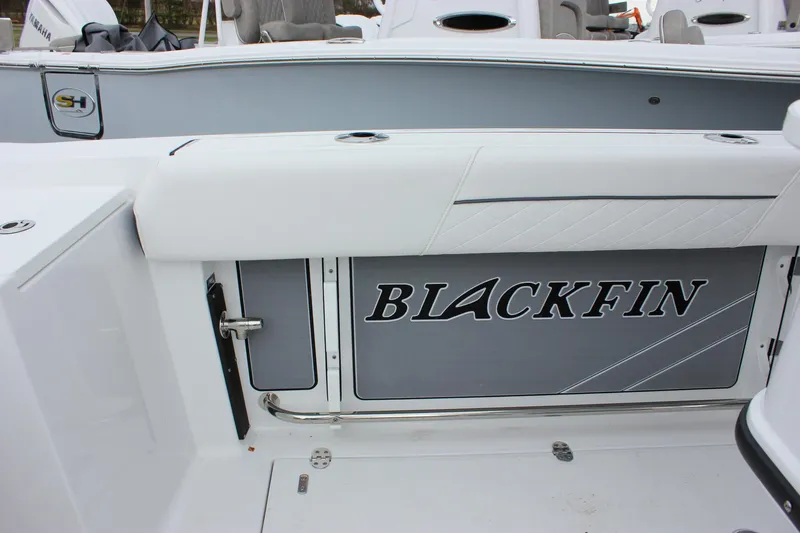 Irish Eyes Yacht Photos Pics 2023 Blackfin 252 CC boat interior with logo and seating area.
