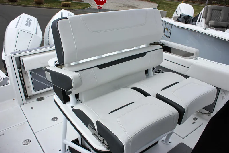 Irish Eyes Yacht Photos Pics 2023 Blackfin 252 CC boat seating with white and black cushioned design.