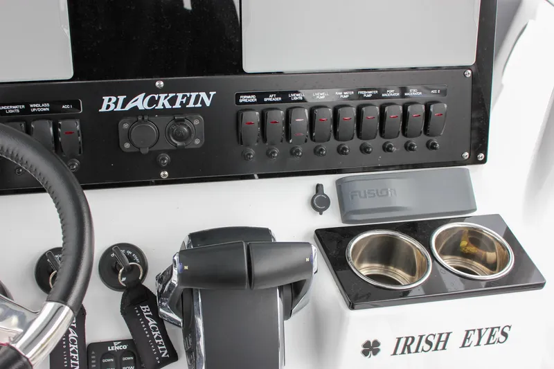 Irish Eyes Yacht Photos Pics 2023 Blackfin 252 CC boat dashboard with controls, cup holders, and "Irish Eyes" label.